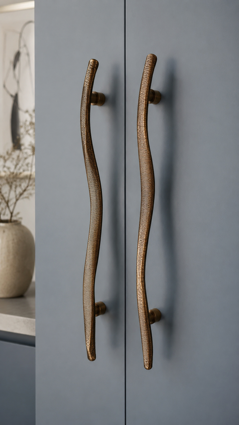 Organic loop bronze door handle on natural wood door with sculptural abstract shape, walnut texture, and modern luxury styling