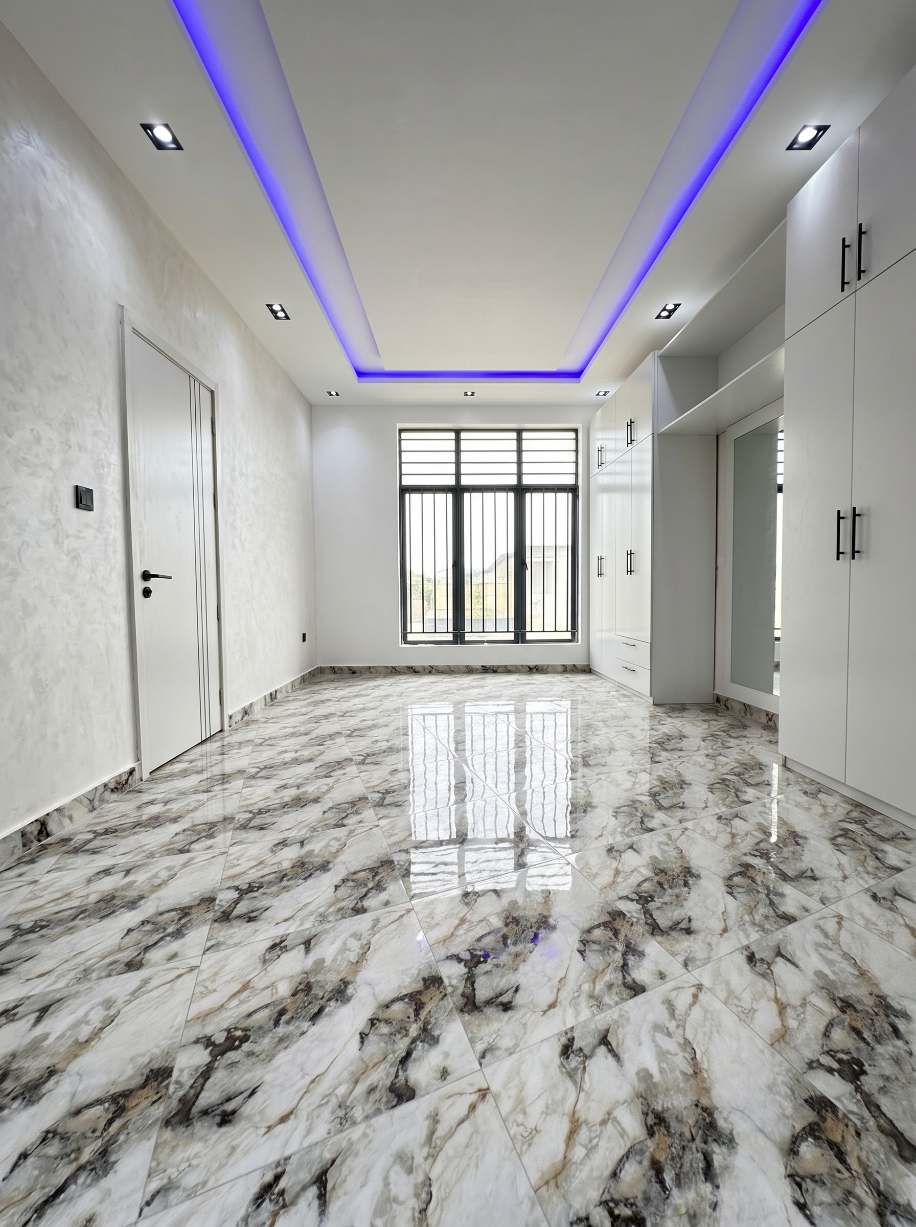 White marble-look bedroom tile flooring with gray veining, leaf-inspired gold accents, stone wall, and modern bedroom decor